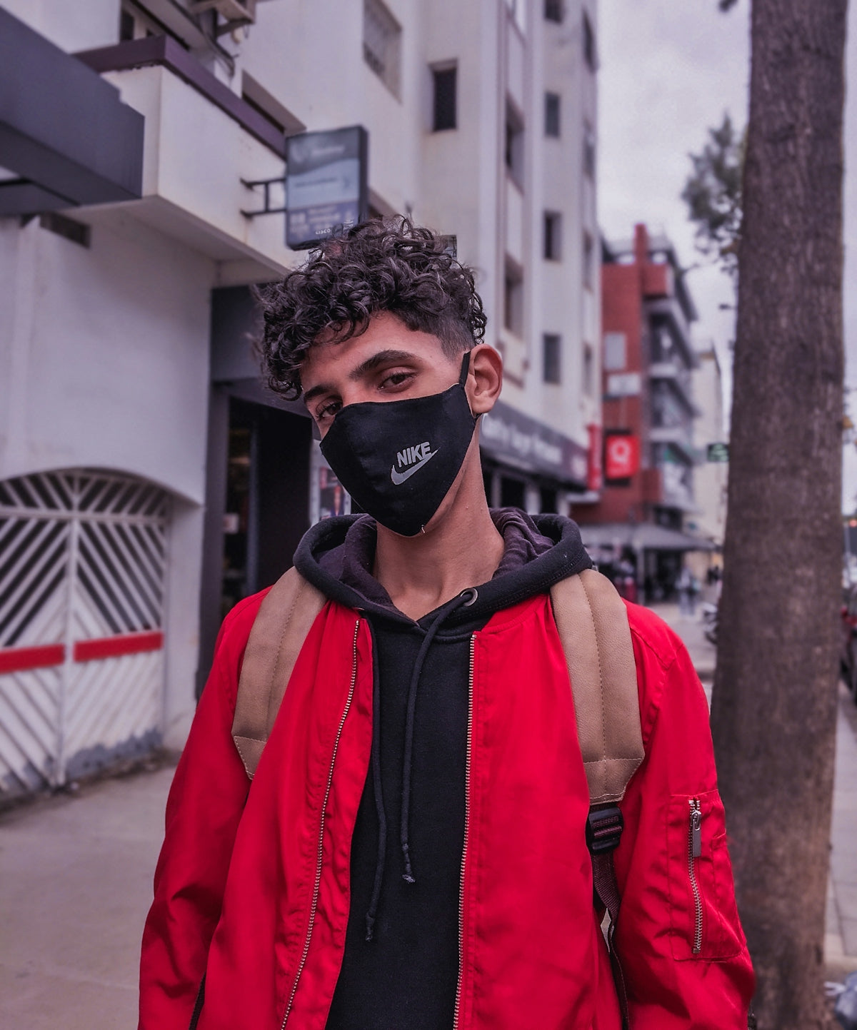 man in red coat wearing black goggles