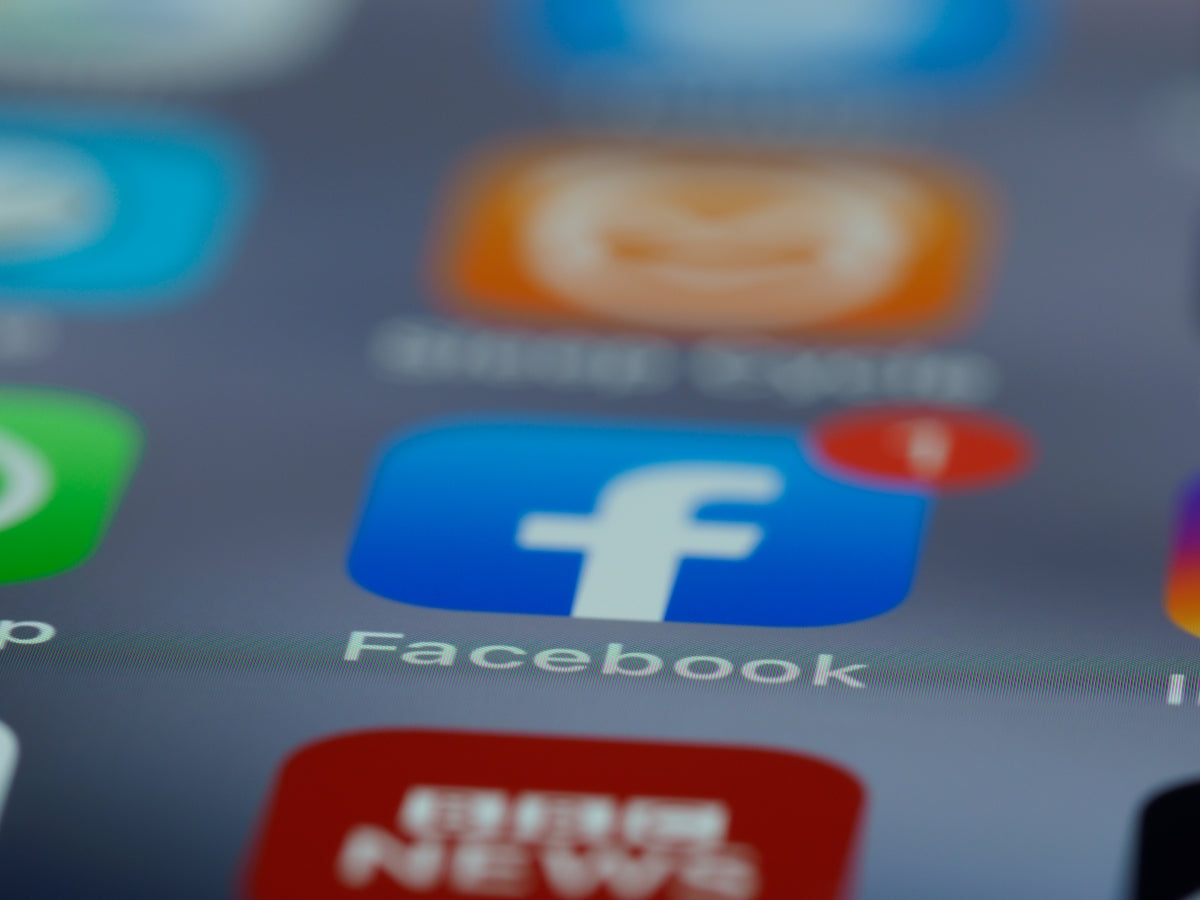 a close up of a cell phone with different social icons on it