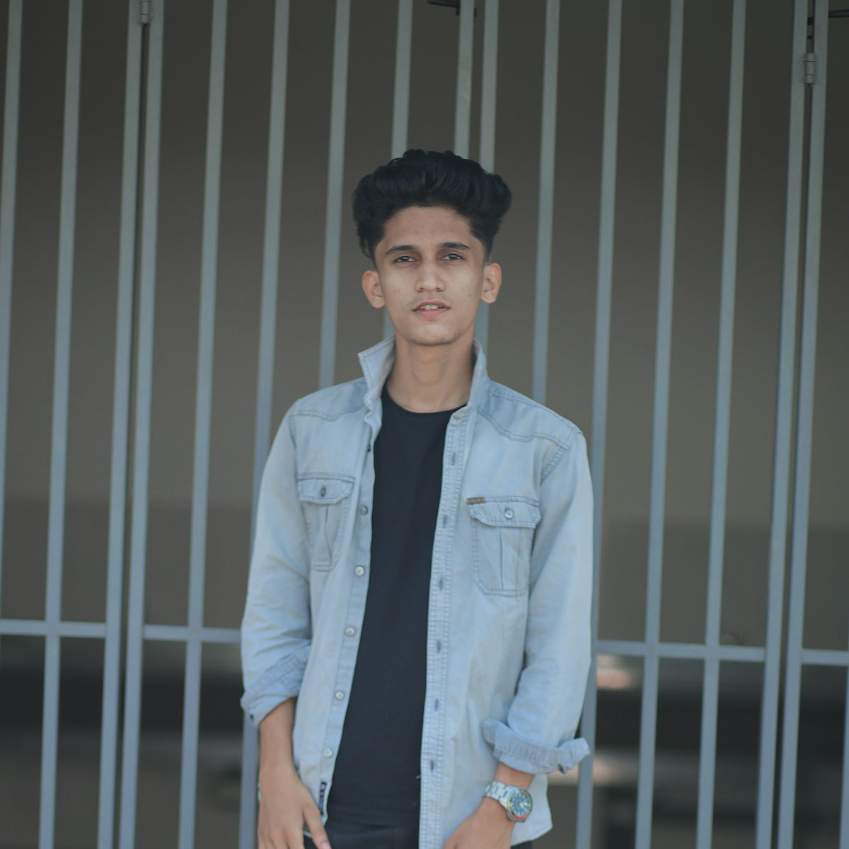 Young man in denim jacket and black t-shirt.