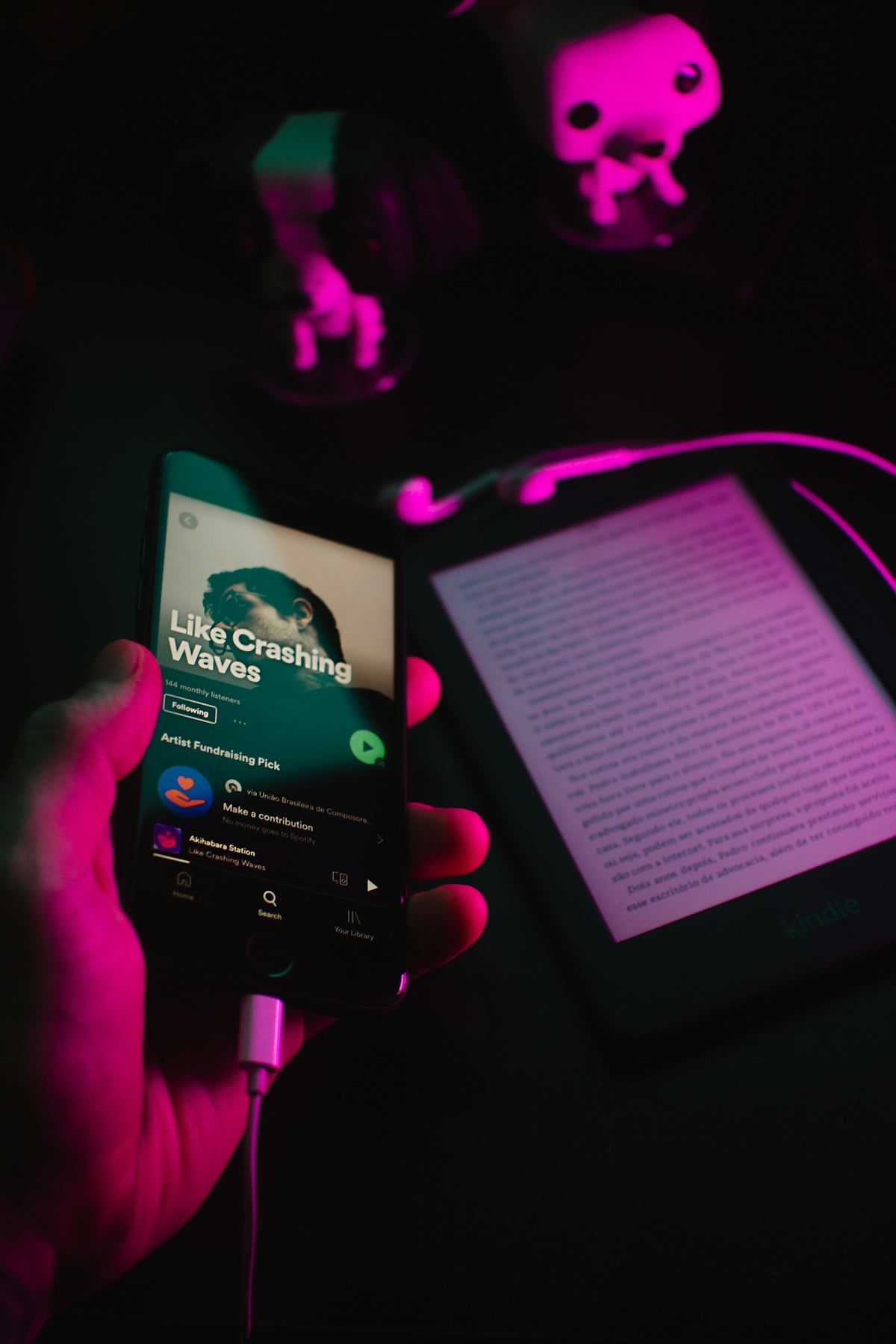 a person holding a cell phone in their hand