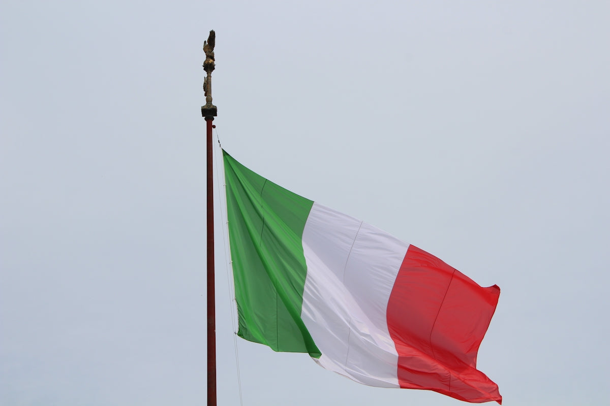 the italian flag is flying high in the sky