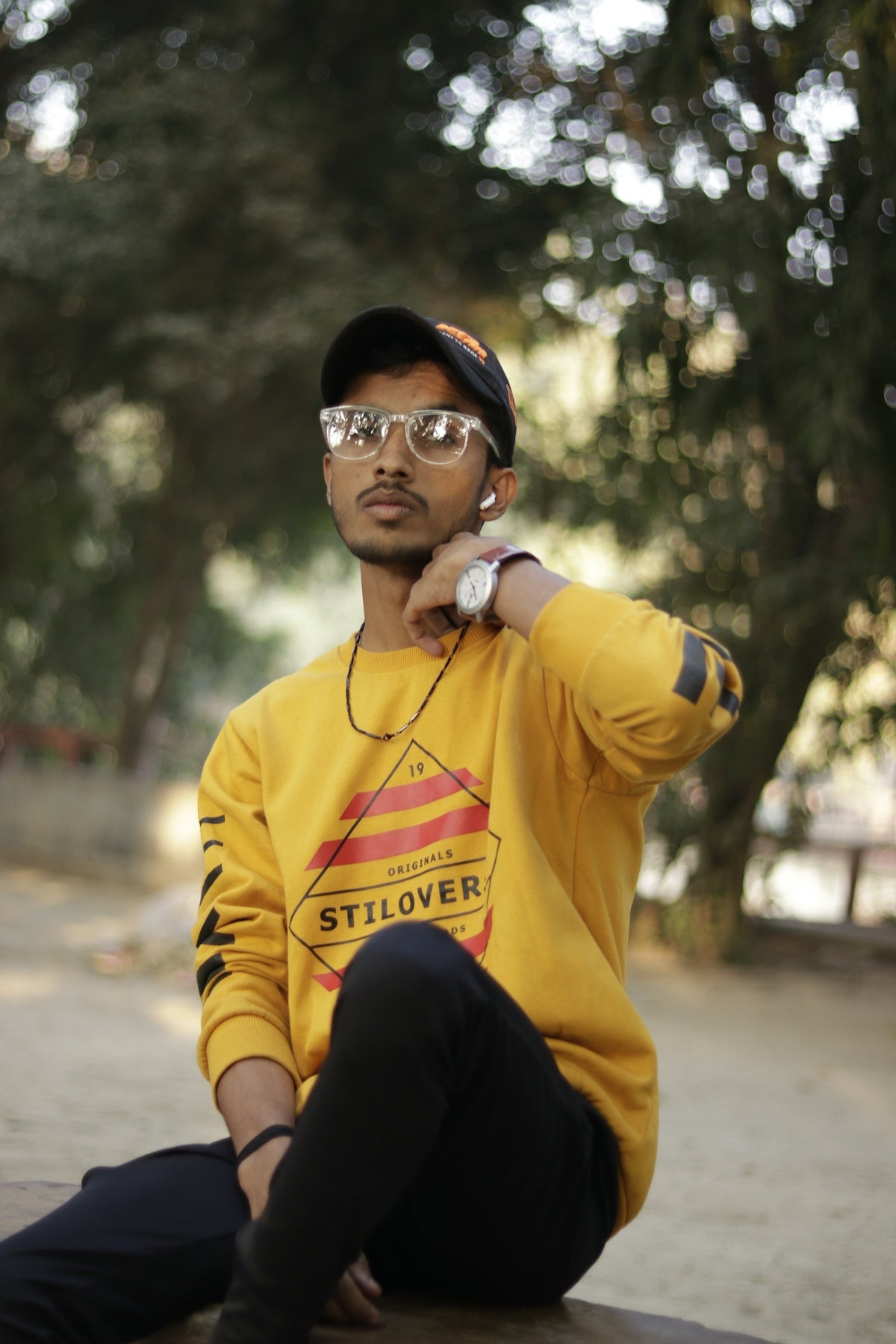 a man sitting on the ground wearing headphones