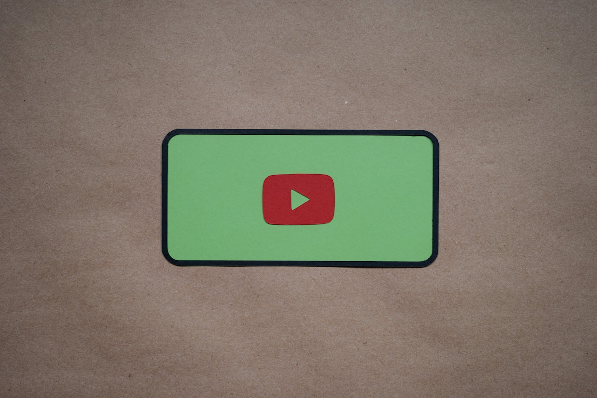 a green screen with a red play button on it