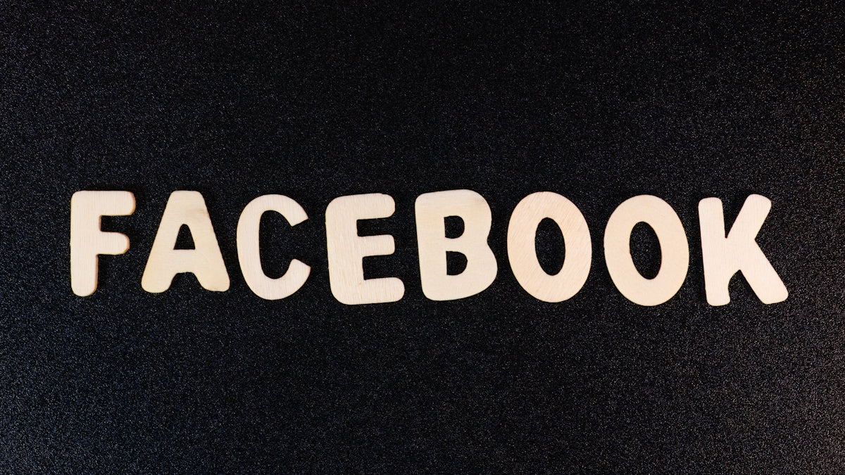 the word facebook spelled with white letters on a black background
