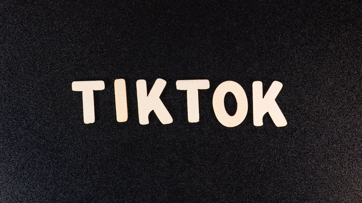 the word tiktok written in white on a black background