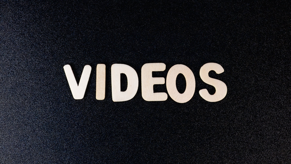 a close up of the word videos on a black background