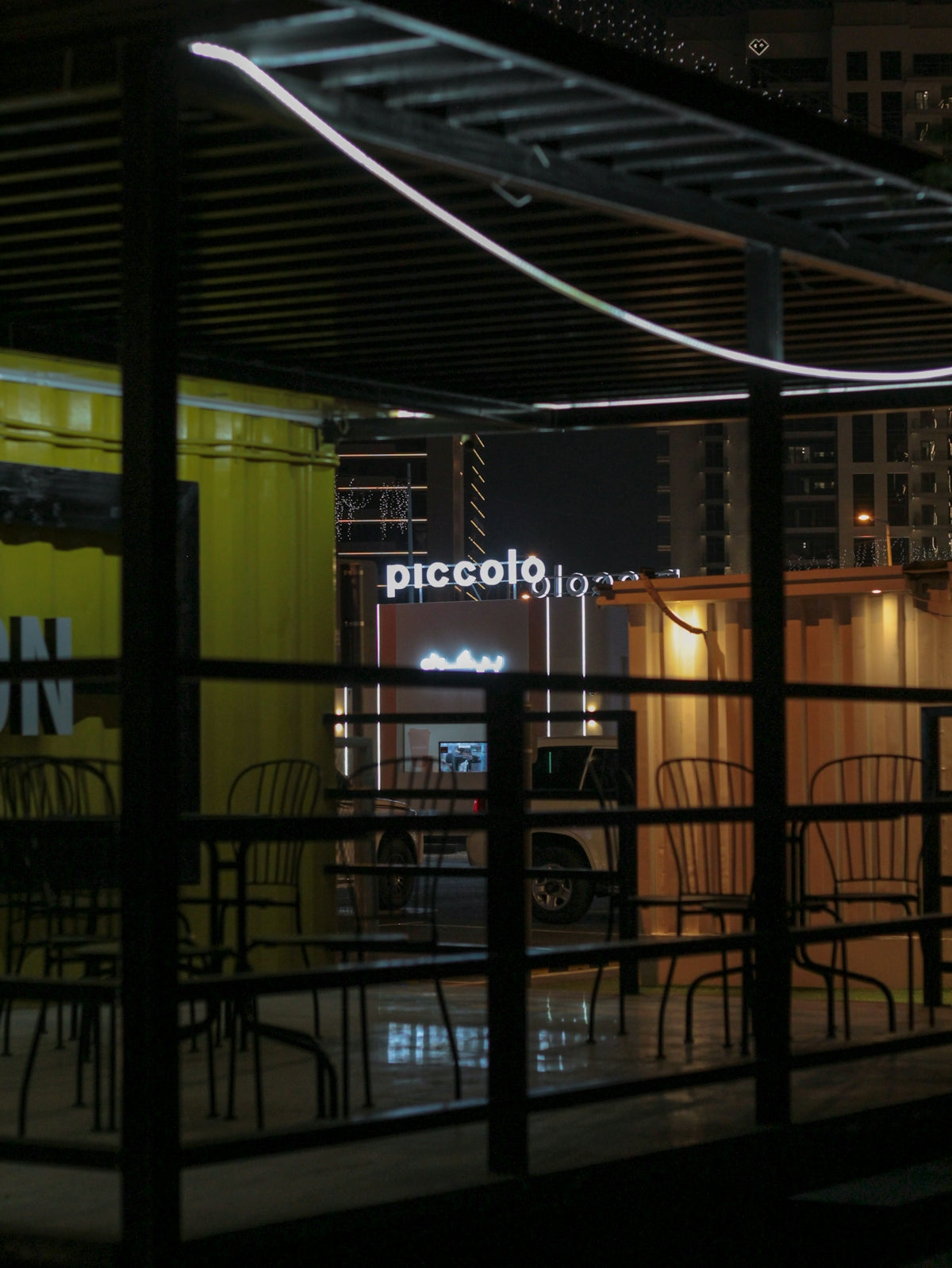 A restaurant at night with tables and chairs