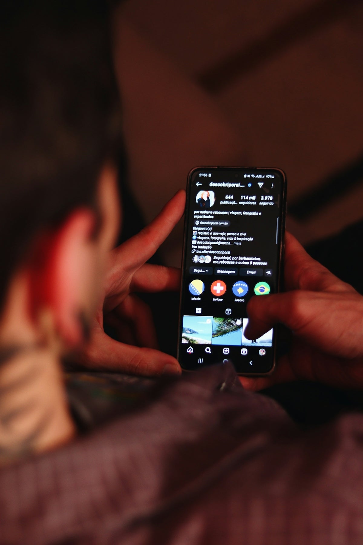 A person holding a cell phone in their hand