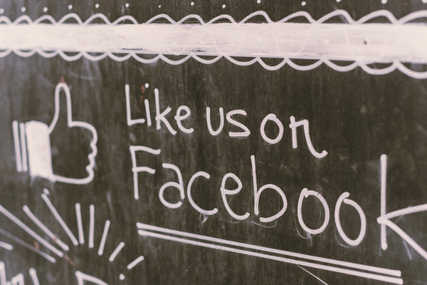 A chalkboard with a message like us on it