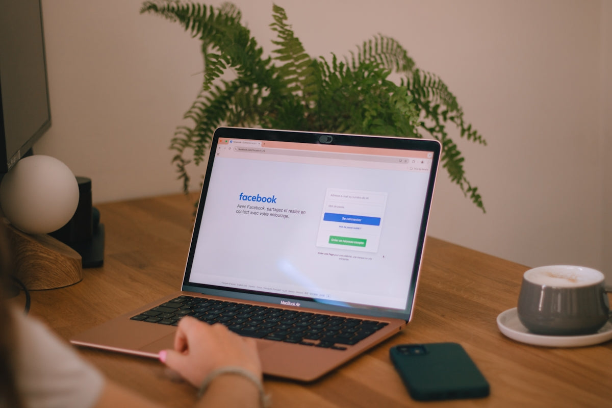 Laptop displays the facebook login page.