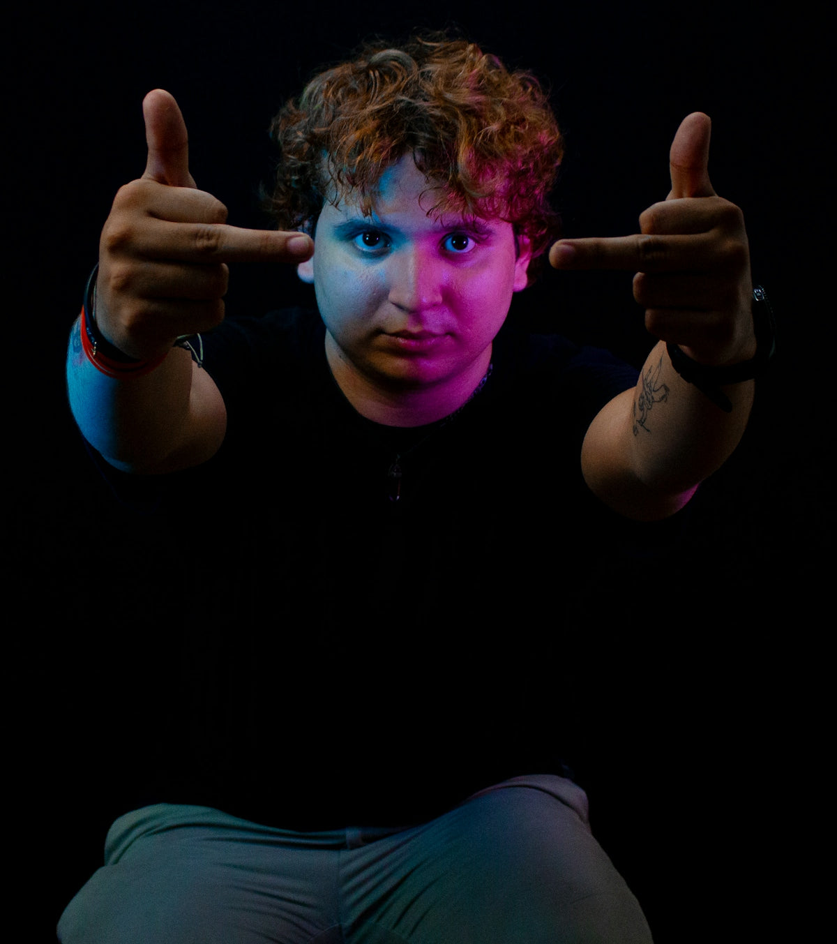 Person with hands gesturing towards face