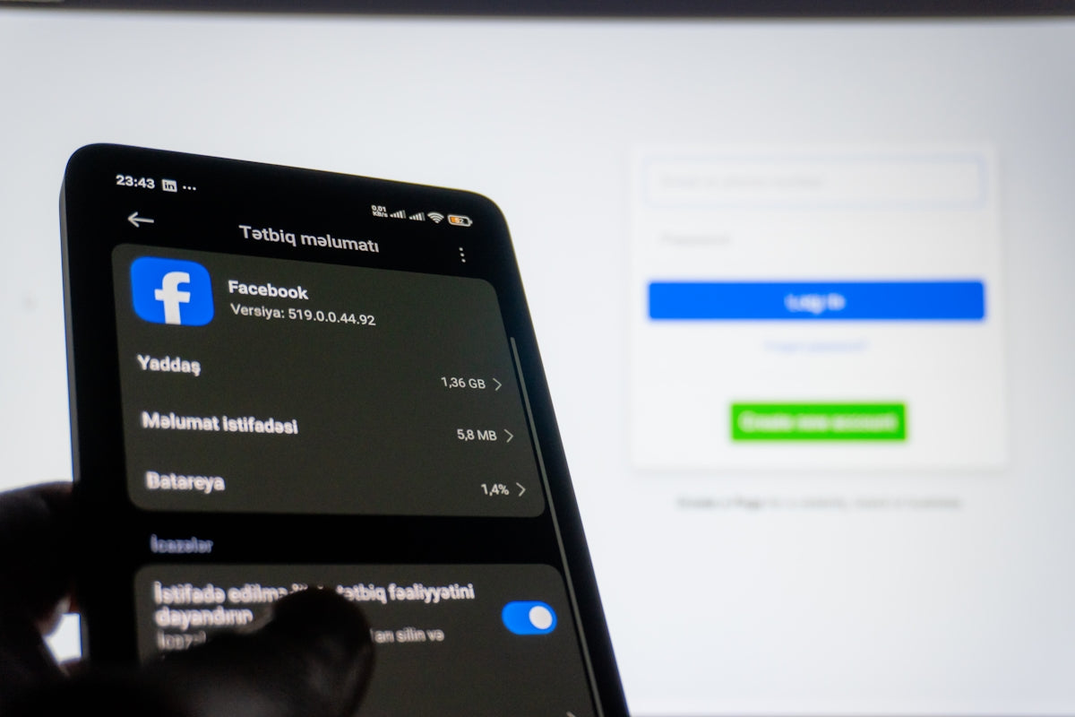 Smartphone displaying facebook settings near login screen