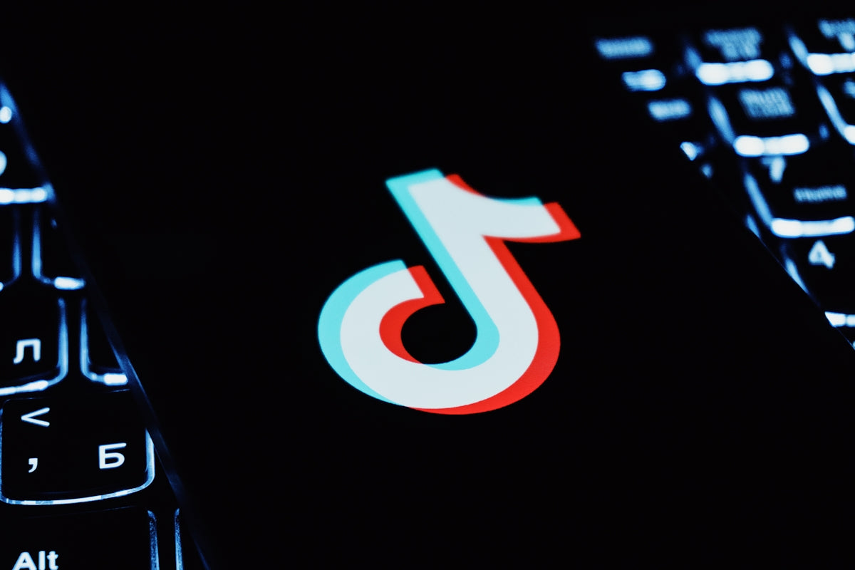 Tiktok logo on a dark keyboard background