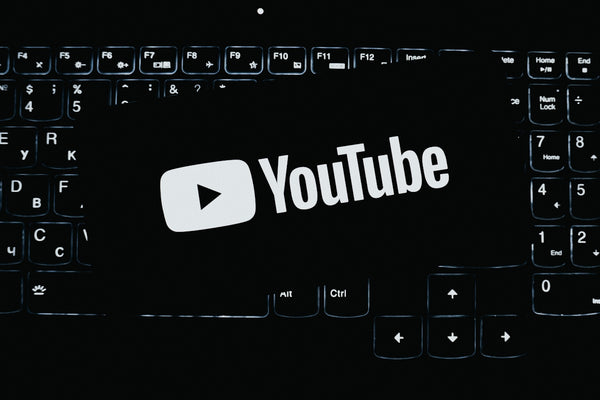 Youtube logo on a dark illuminated keyboard