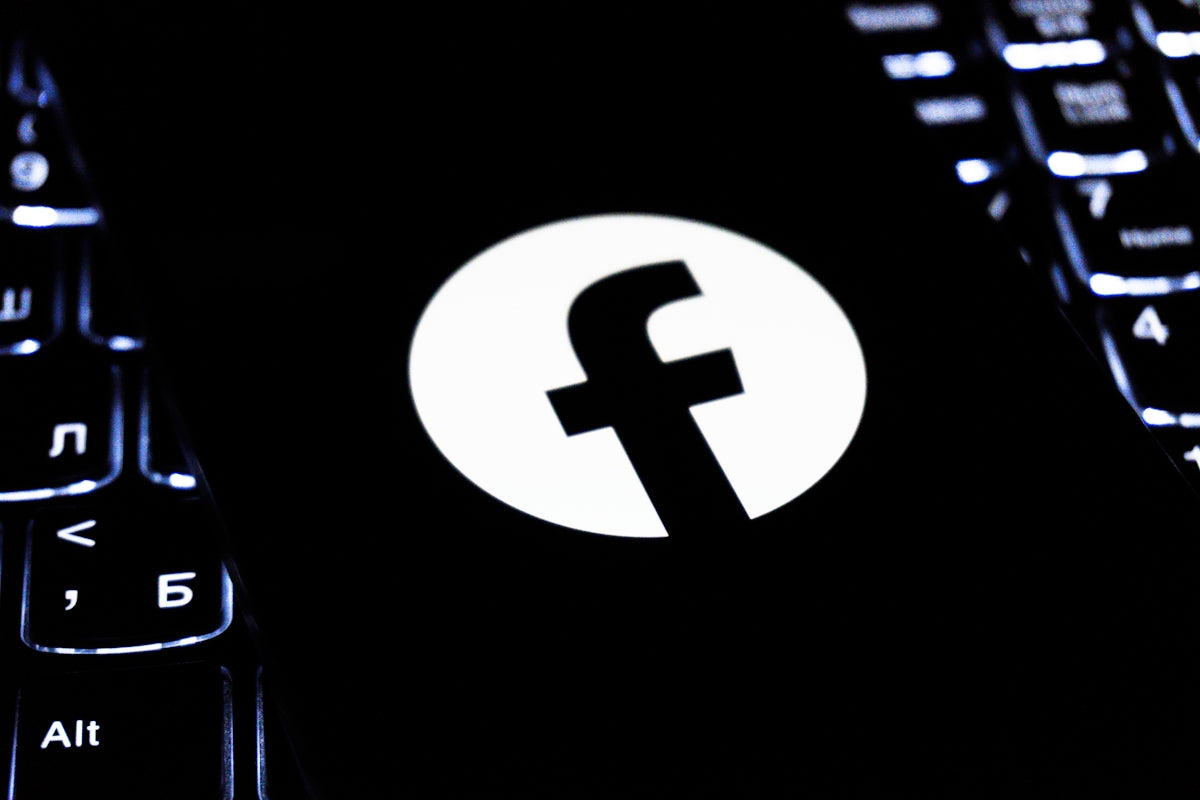 Facebook logo on a dark keyboard