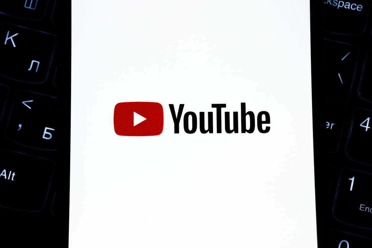 Youtube logo on a white background with keyboard.