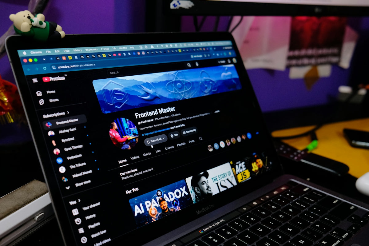 A laptop screen displaying a YouTube channel page with a dark interface