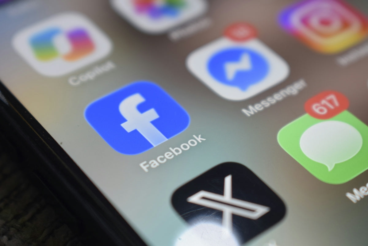 A smartphone screen displaying various social media app icons including Facebook and Messenger